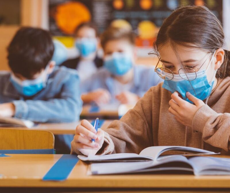 Class of children with face coverings